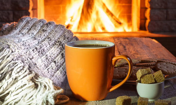 istock Mug for tea or coffee, woolen things near cozy fireplace 2159066272