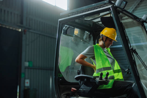 istock Woman sitting in a forklift in a warehouse 2159067728