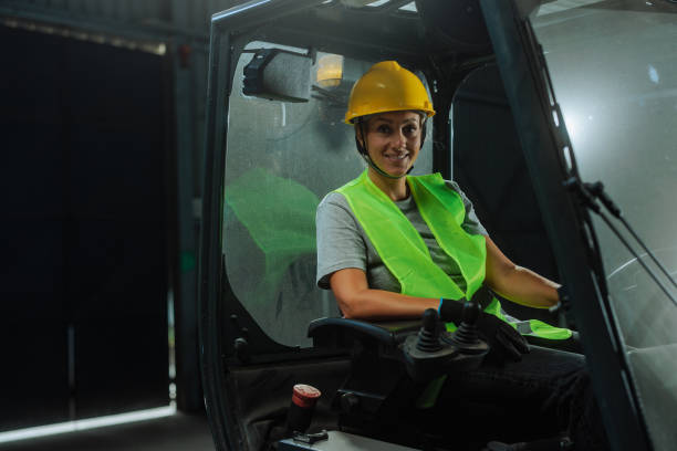 istock Woman posing and smiling in a forklift 2159067735