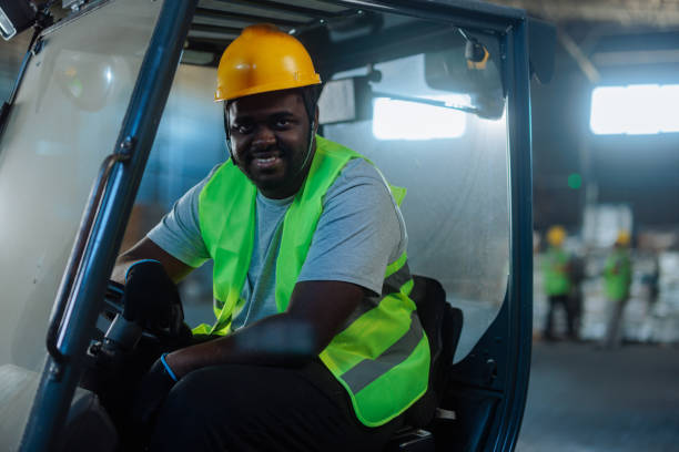 istock Worker sitting in a forklift, smiling and posing for a photo 2159067745
