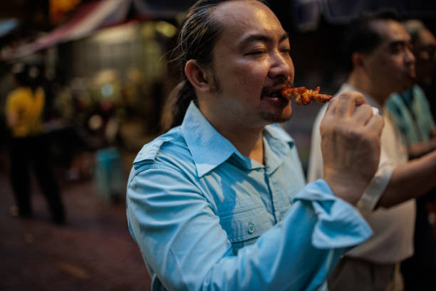 istock Man eating authentic Thai food 2159067931