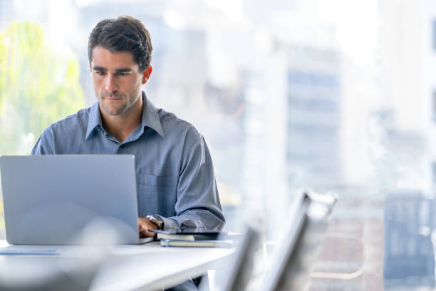 istock Serious Businessman working on a laptop computer in the office. 2159068549