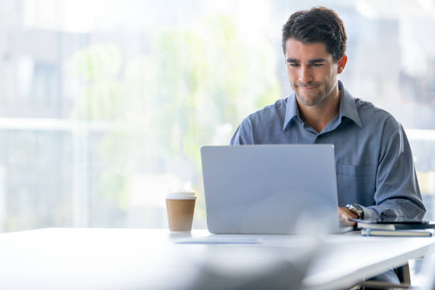 istock Serious Businessman working on a laptop computer in the office 2159070307