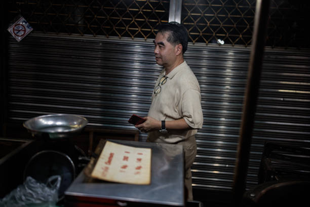 Thai man choosing street food at the marketplace in Bangkok, Thailand.