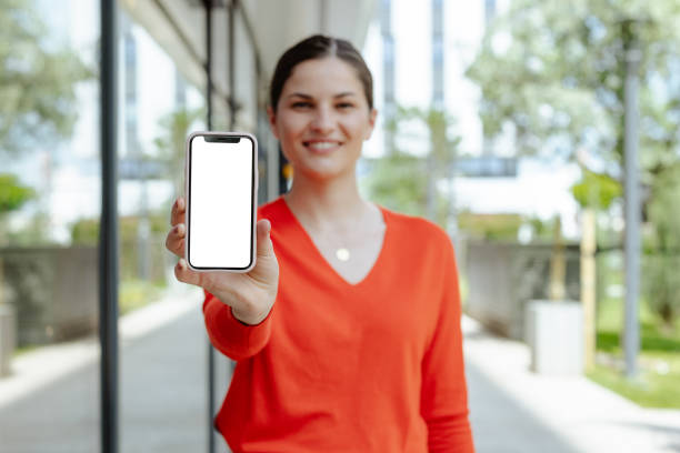 istock Young woman showing smart phone with white screen 2159071830