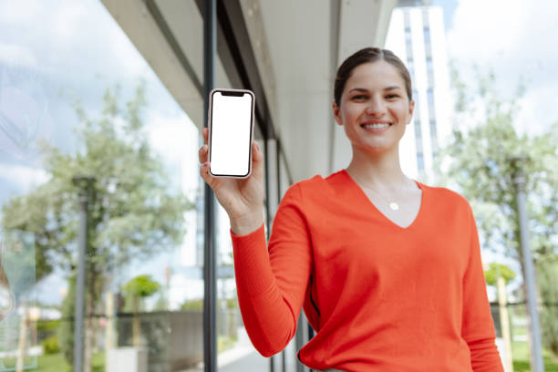 istock Young woman showing smart phone with white screen 2159071875