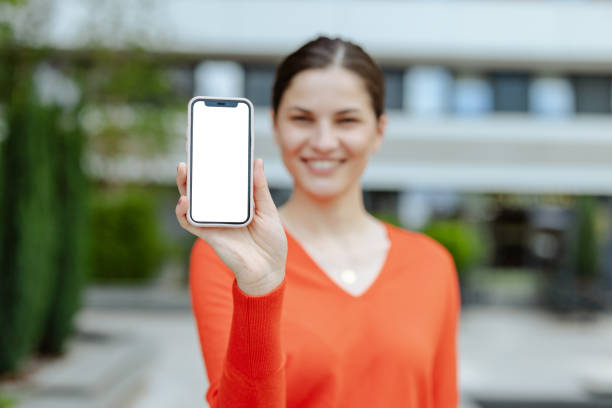 istock Young woman showing smart phone with white screen 2159071940