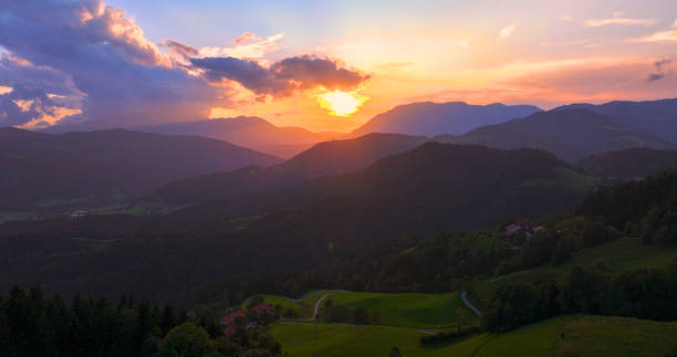 istock AERIAL, LENS FLARE: Majestic sunset over the hills, with sun casting a warm glow 2159072533
