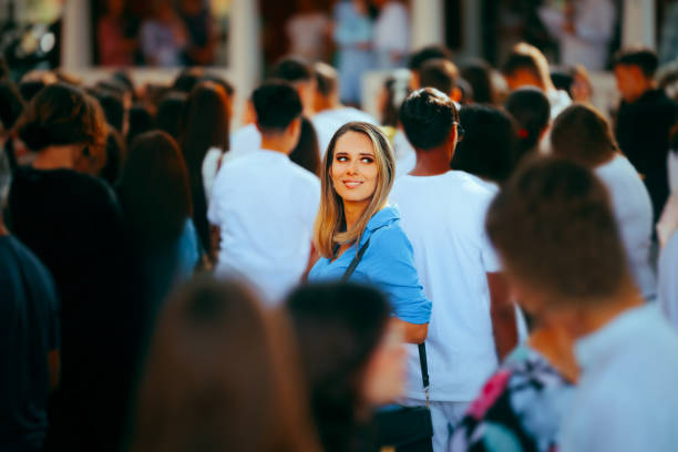 Smiling Woman in a Crowded Place Standing Out