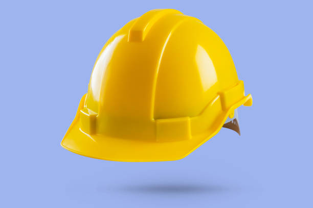 istock Yellow safety construction helmet on blue background 2159080974