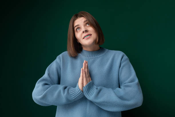 Woman in Blue Sweater Praying
