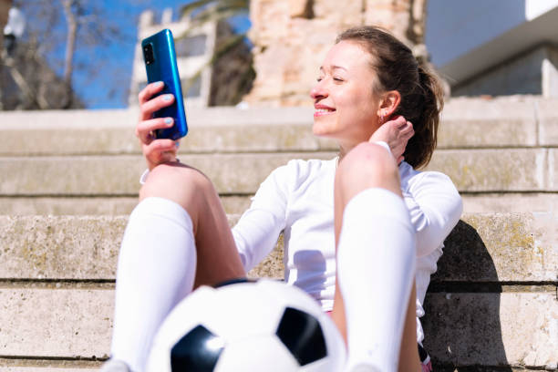 istock female soccer player resting using mobile phone 2159081297