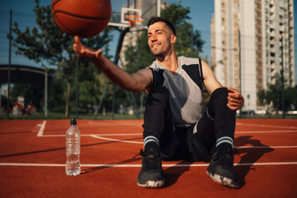 istock Basketball player spinning ball on finger while on the outside court playing 2159081905