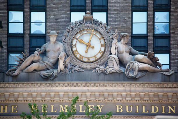 Detail of the clock with greek sculptures on the facade of the Hemsley Building in Park Avenue, Manhattan, New York City