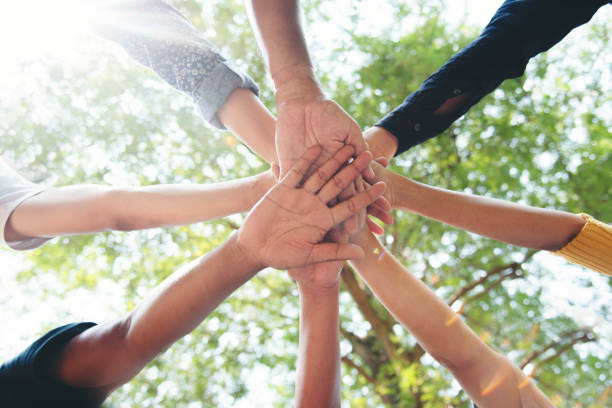 istock Diverse multiethnic Partners hands together teamwork group of multiracial people meeting join hands togetherness. Diversity people hands join empower partnership teams connection volunteer community 2159095191