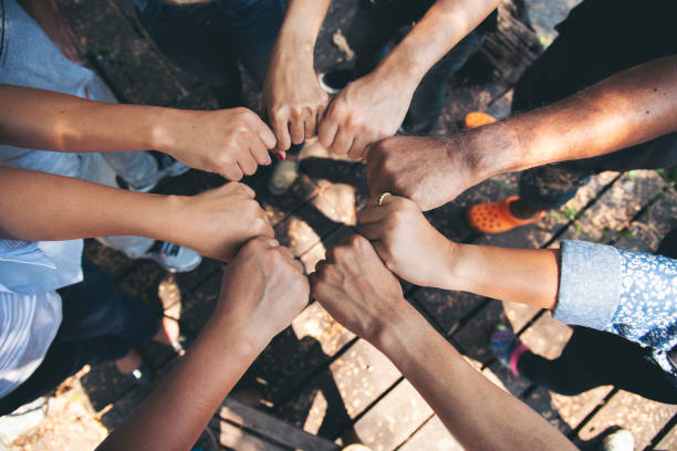 istock Diverse multiethnic Partners hands together teamwork group of multiracial people meeting join hands togetherness. Diversity people hands join empower partnership teams connection volunteer community 2159095196