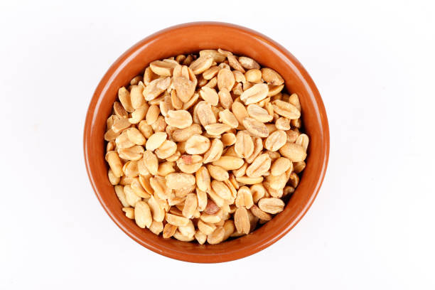 istock roasted peeled peanuts in ceramic bowl isolated on white background 2159097286