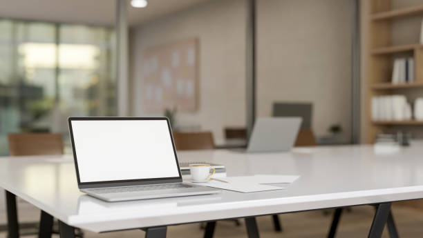 istock A laptop computer with a white-screen mockup on a meeting table in a meeting room. 2159097537