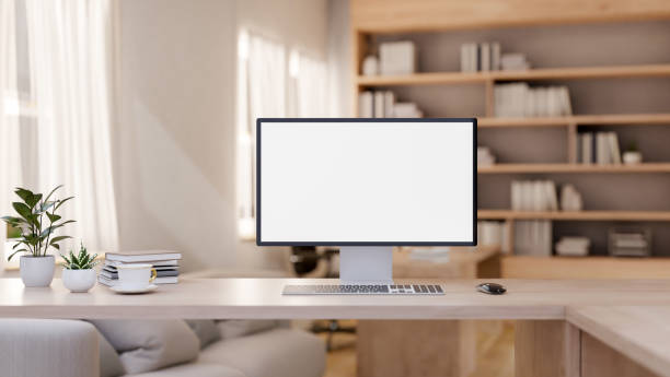 istock A minimalist, comfortable home office features a computer on a wooden table in the living room. 2159097542