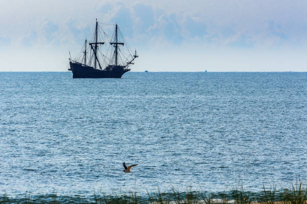 Old tall ship on Mediterranean sea over sky in Antalya, Turkey