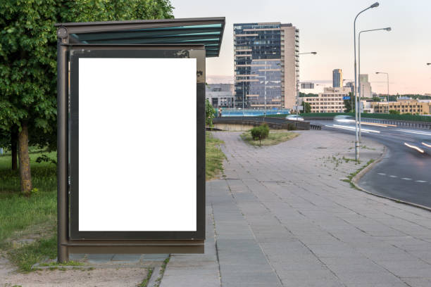 istock Blank White Bus Stop Vertical Poster Billboard Mockup In Front Of City Skyline Backdrop 2159102158