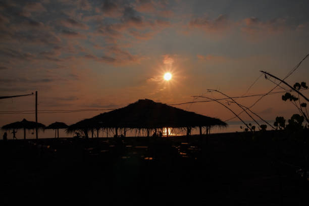 istock Morning sunlight on the beach with thatched roof gazebo 2159105257