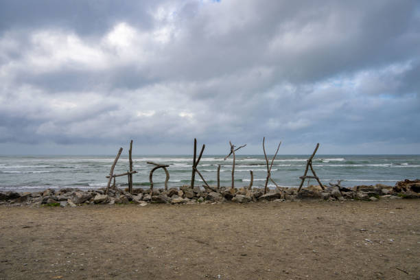 Hokitika Sign Made of Branches on Beach