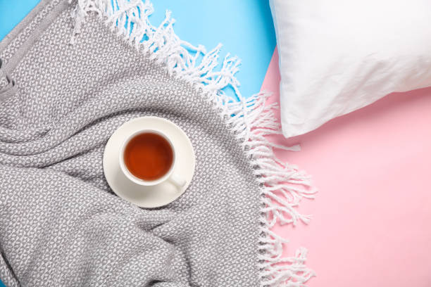 istock White pillow and blanket with tea cup on pink blue background 2159114289