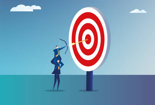 istock Two business men team up to shoot an arrow into the bull's eye 2159116589