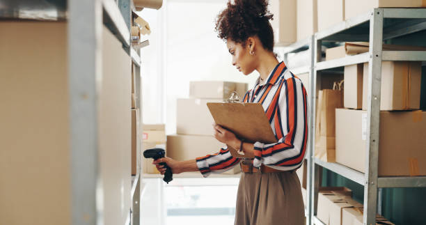 Woman, boxes and scanner with clipboard for logistics, e commerce or inventory management of order or courier. Seller or entrepreneur with barcode for price, information or package delivery checklist