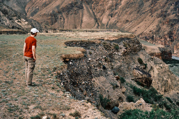 istock Hiker is standing above canyon and looking at view 2159117185