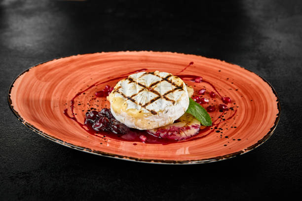 istock Grilled Camembert Cheese with Berry Sauce on a Rustic Plate 2159117396
