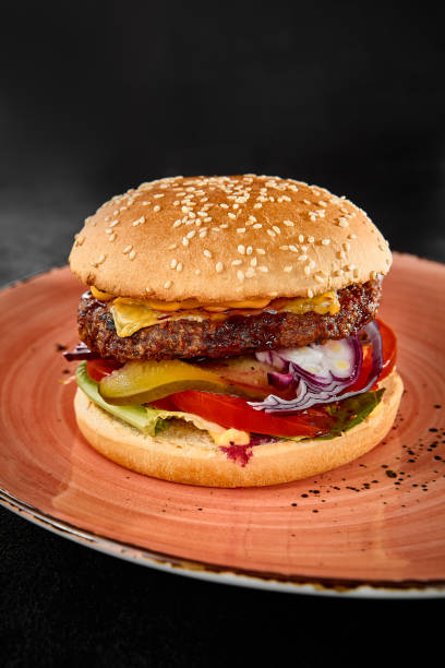 istock Delicious Beef Burger with Fresh Vegetables on Sesame Seed Bun 2159118378