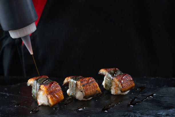 istock Japanese chef flavors Unagi Eel Nigiri Sushi (Eel Sushi) with sauce 2159120638
