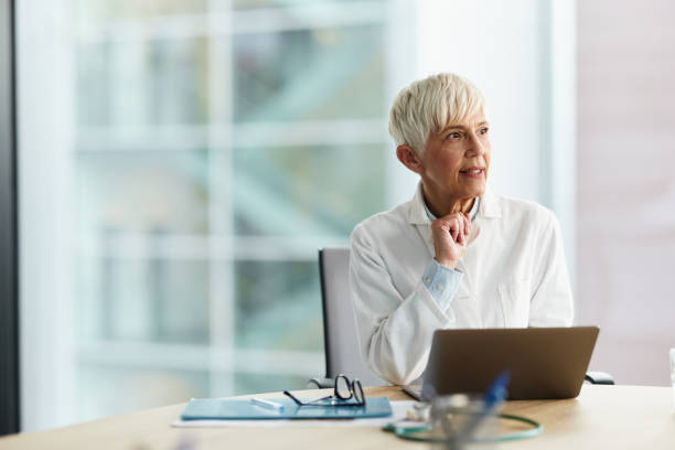 istock Pensive female doctor working on laptop at her office. 2159122914