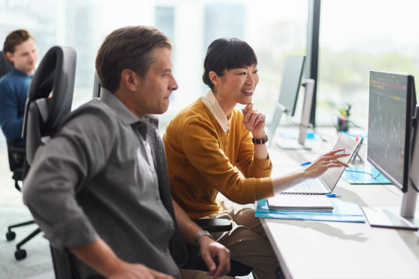 istock Business colleagues reading codes on desktop PC in the office. 2159123499