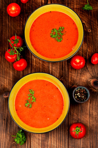 istock Bowl of tomato soup on a wooden table. 2159123847