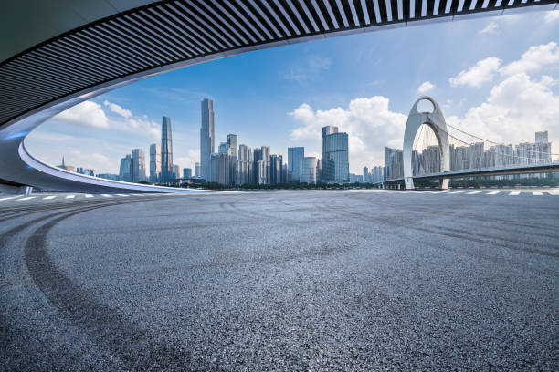 istock Road and city skyline background 2159124101