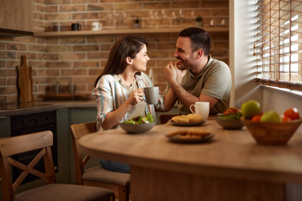 istock Loving couple talking during morning coffee in dining room. 2159124333