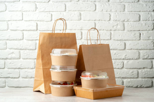 istock Take out food in boxes and craft bag against brick background 2159124446