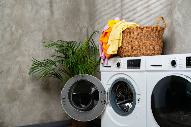 istock Modern White Washing Machines in Laundry Room With Open Door 2159124467