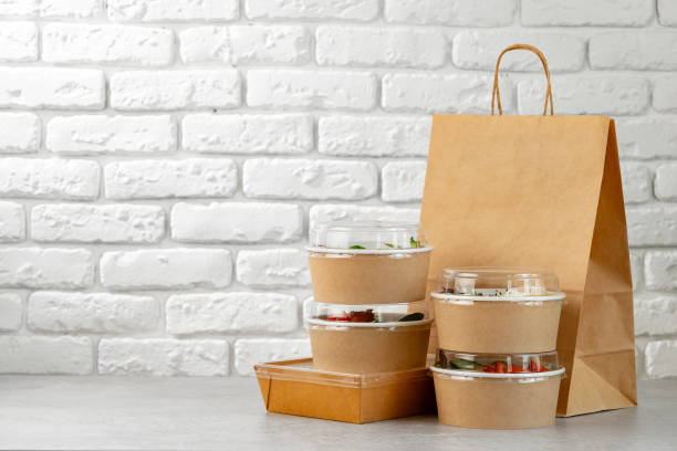 istock Take out food in boxes and craft bag against brick background 2159125686