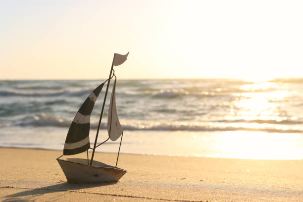 istock Small vintage boat on beach at summer sunset 2159126647