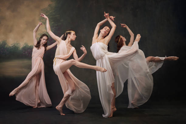 istock Ballerinas in elegant dresses perform synchronized dance, reminiscent of classical ballet traditions against vintage studio background. 2159128277