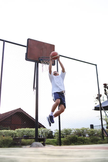 istock Playing Basketball Outdoors 2159128390