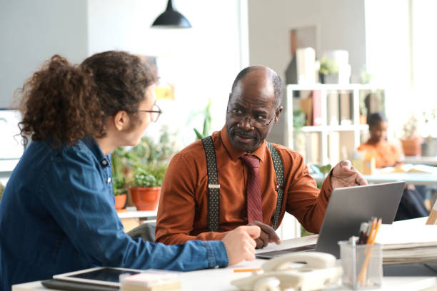 istock Black Senior Man Talking to Young Colleague 2159129446