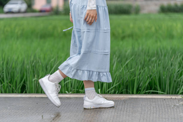 Footsteps of a young girl walking through rice fields
