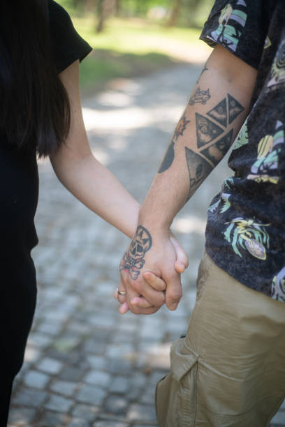 istock Couple holding hands outdoor closeup 2159130650