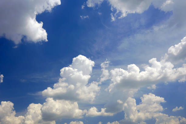 Large white beautiful clouds against the blue sky during the day. Background or template for design.