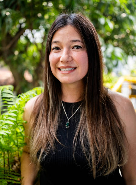 istock Smiling mid adult female looking at camera while standing outside 2159132803